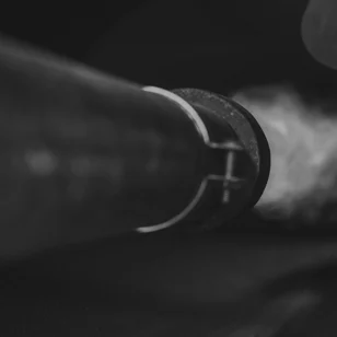 Close-up of an industrial burner combustor component at an oilfield facility