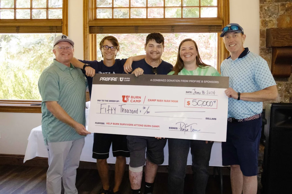 Photo from the 2024 Profire Golf Tournament presenting a check to the Burn Camp representatives.