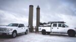 Two Profire service trucks on site in the snow.