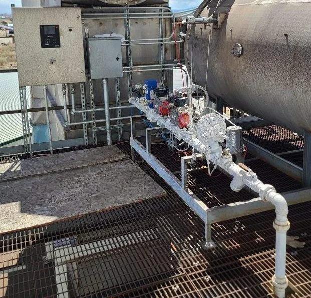 The image shows a mounted fuel train line leading to a vessel from the bottom right to the middle of the image. On the top left side there is a PF3100 BMS Control Panel.