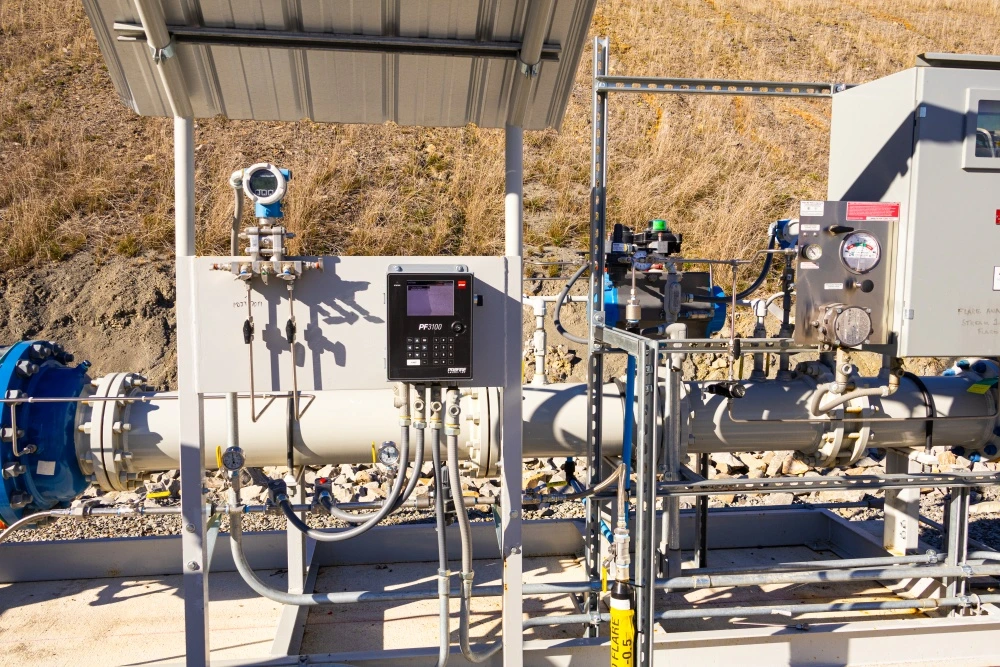 Flare site piping with instrumentation, pressure gauges, and an electronic control panel mounted on a skid.