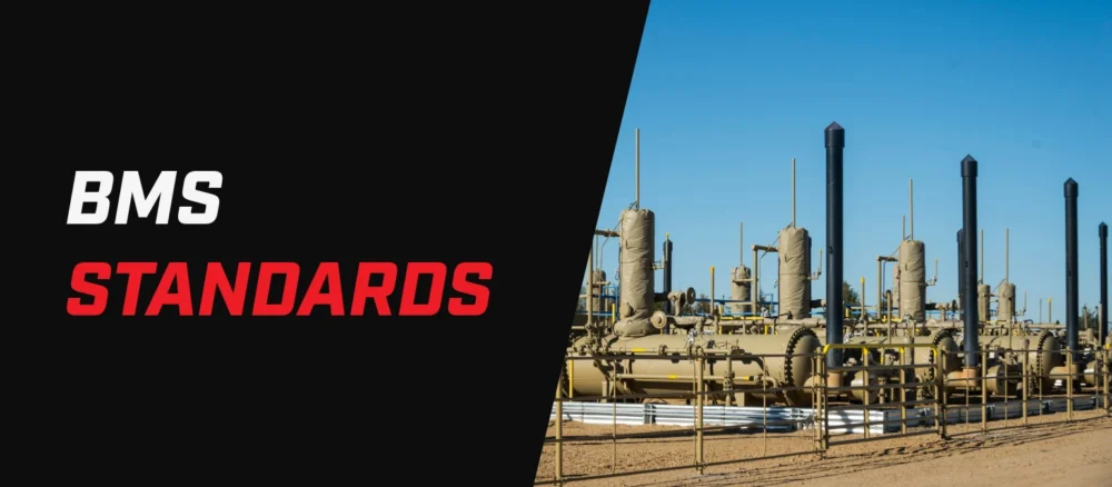 Banner with the text “BMS Standards” beside an outdoor oil and gas facility with multiple vessels, piping, and vertical exhaust stacks.