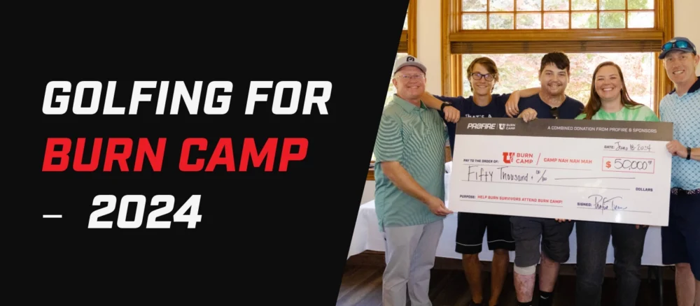 Banner with the text “Golfing for Burn Camp — 2024” beside a group of five people holding a large donation check for Burn Camp indoors.