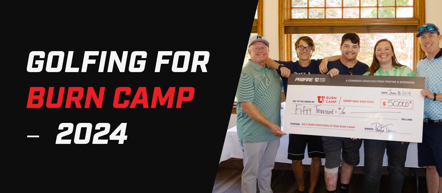 Banner with the text “Golfing for Burn Camp — 2024” beside a group of five people holding a large donation check for Burn Camp indoors.