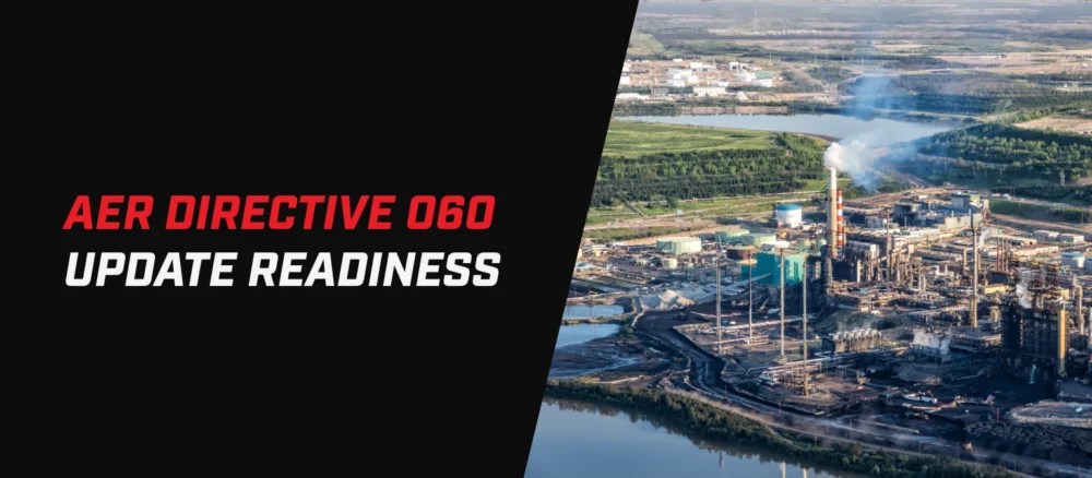 Banner graphic titled “AER Directive 060 Update Readiness.” The left side features a black background with the title in large italicized text, with “AER Directive 060” in red and “Update Readiness” in white. The right side shows an aerial view of a large industrial oil and gas processing facility with storage tanks, smokestacks emitting steam or smoke, waterways, and surrounding forested landscape. A diagonal black divider separates the text and facility image.