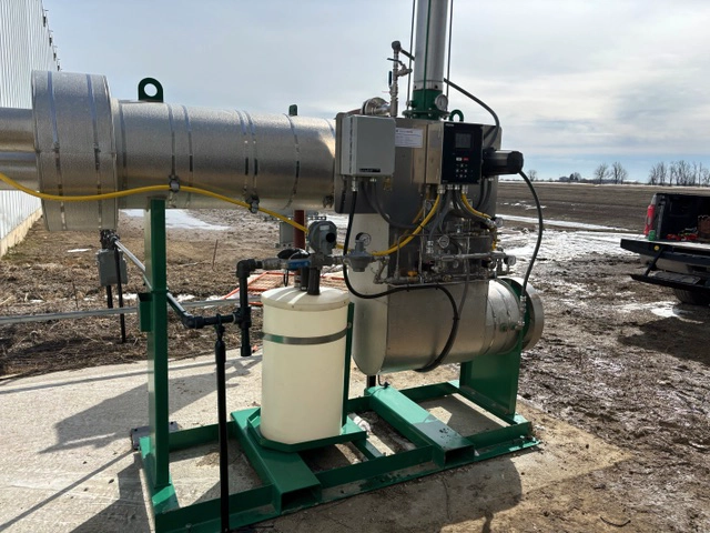 Side view of the complete skid-mounted heater package with an insulated chamber, PF2200 controls, piping, and reservoir.