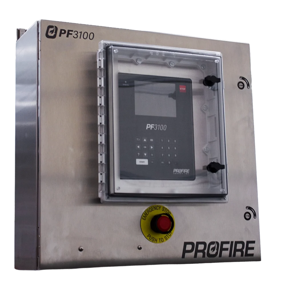 Front-left view of a Profire PF3100 controller installed in a stainless steel industrial control cabinet. The enclosure features a clear protective door over the controller interface, a keypad and display, a red emergency stop button, and PROFIRE branding on the front panel.
