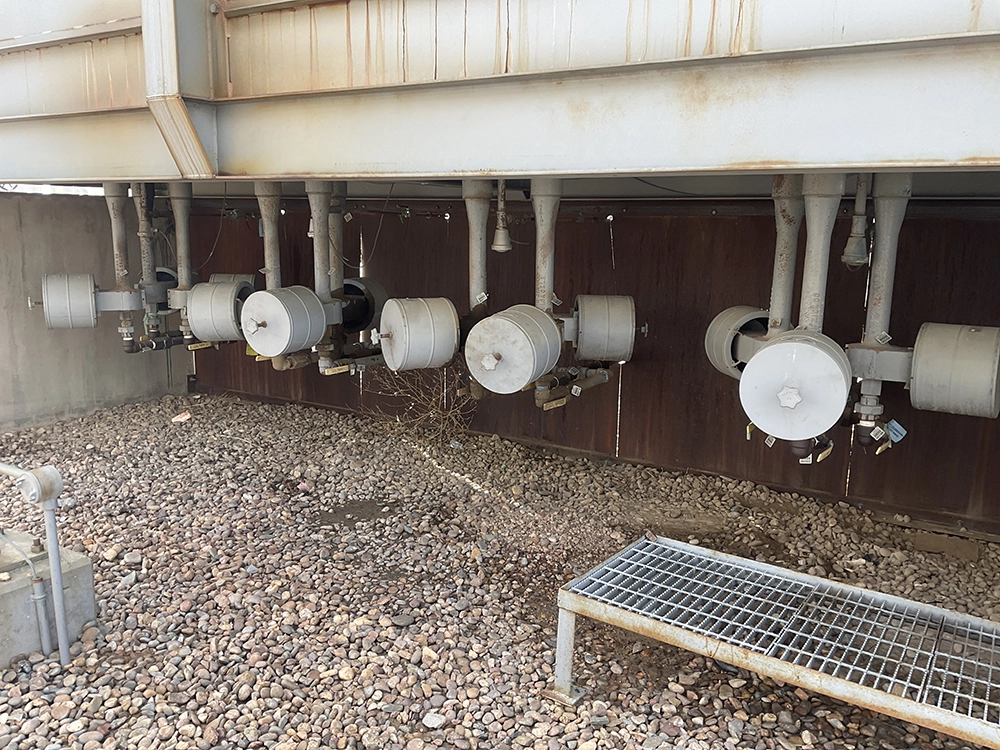 Row of burner assemblies and air housings mounted along the side of an industrial heater.