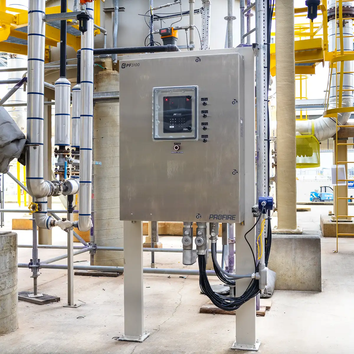 Profire PF3100 control panel on a pedestal at an industrial plant surrounded by piping and steelwork